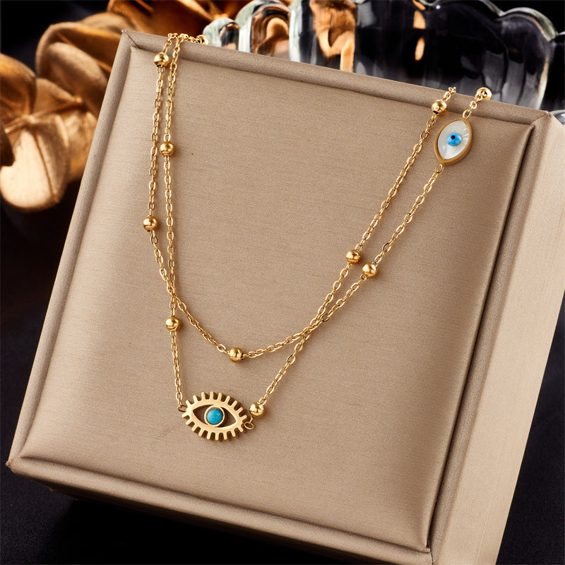 Minderheiten-Modedesign Doppellagige Mix-Kette Goldkugeln Titanstahl Tropföl Hohlblaue Augen Anhänger Halskette