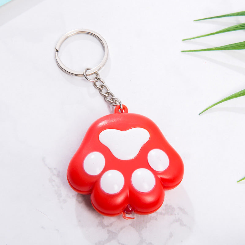 Llavero con diseño de pata de gato para otoño e invierno, con colgante de campana, luminoso, emite sonido, regalo creativo para funda de teléfono móvil, accesorios de interior de coche