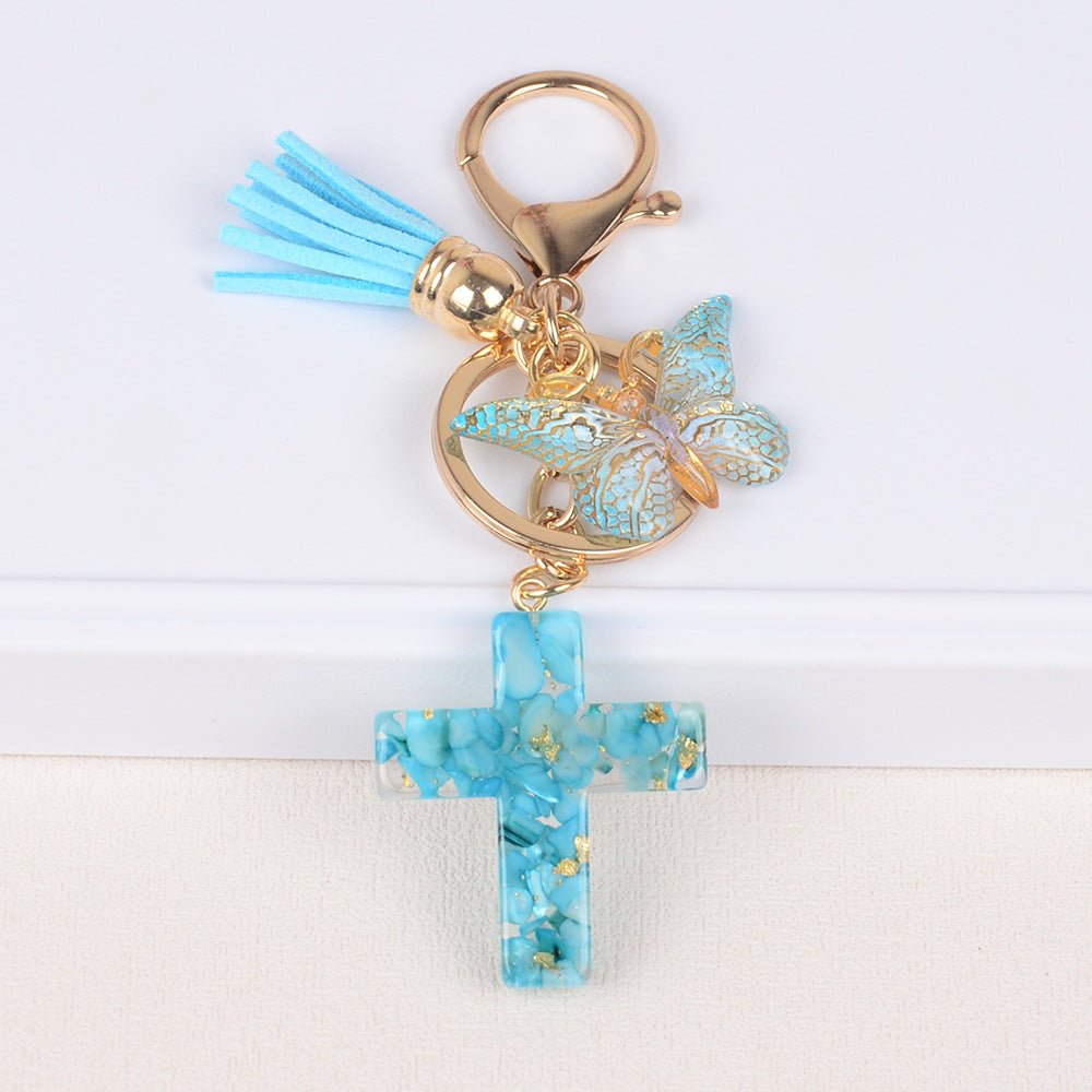 Llavero de cruz con borla y mariposa de piedra