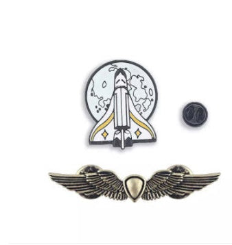 Broche de goteo de aceite con insignia M dorada