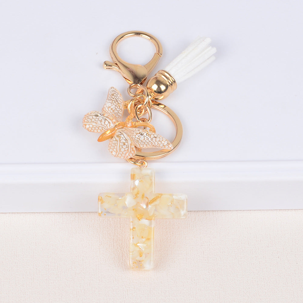 Llavero de cruz con borla y mariposa de piedra