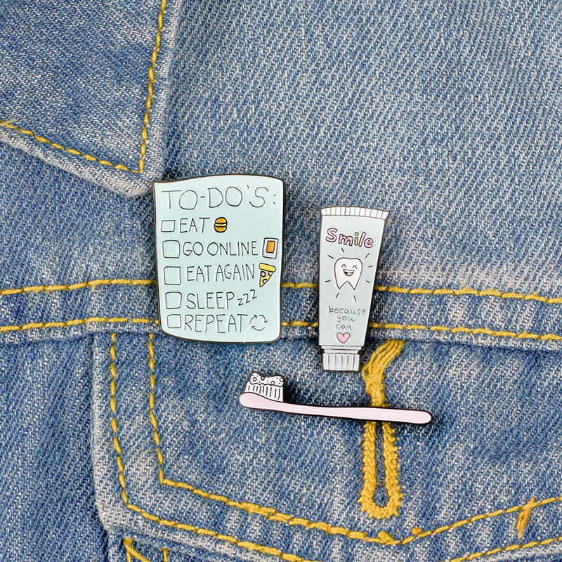 Lindo broche de pasta de dientes y cepillo de dientes de dibujos animados