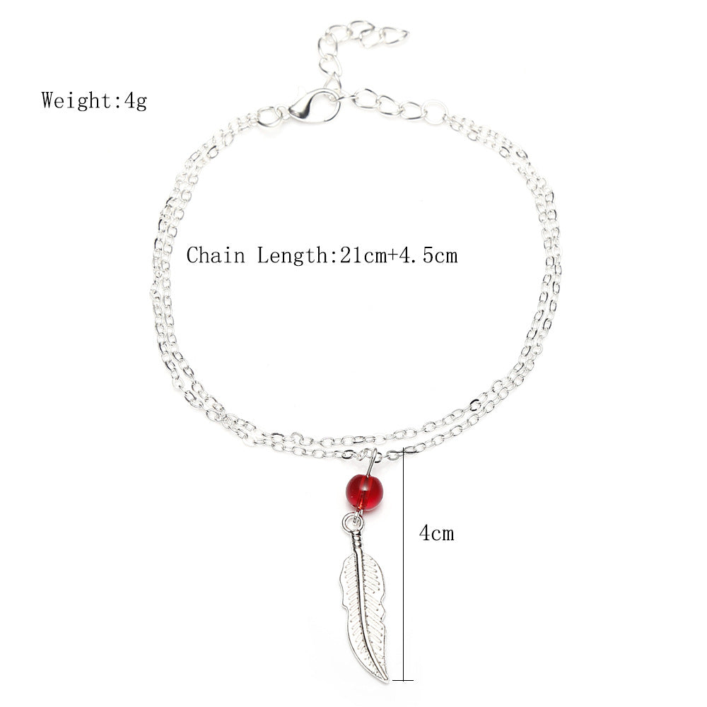 Tobillera de plumas con cuentas de cristal