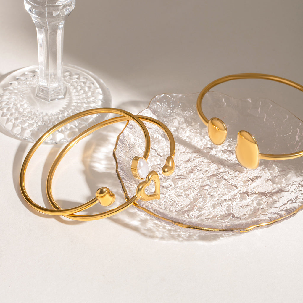 Pulsera abierta de acero inoxidable con forma de gota de agua irregular