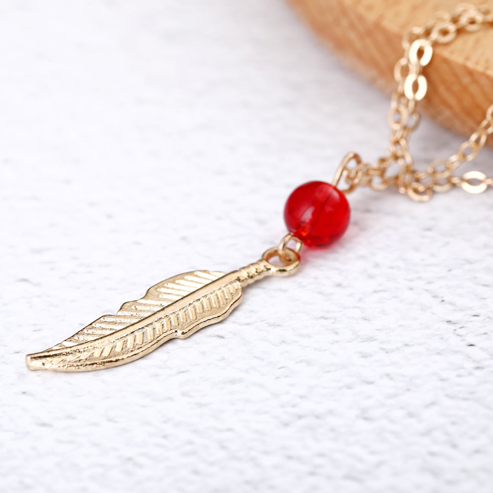 Tobillera de plumas con cuentas de cristal