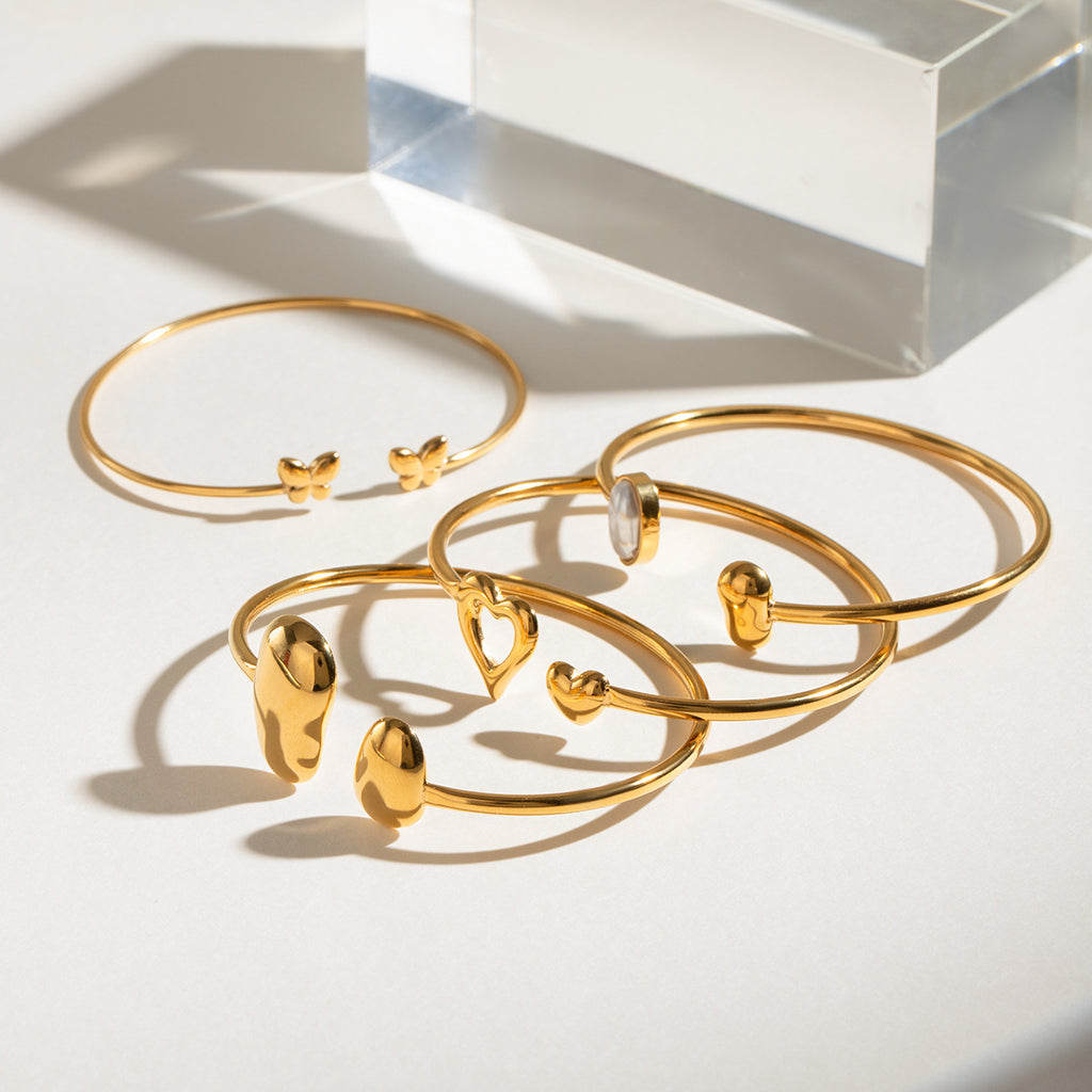 Pulsera abierta de acero inoxidable con forma de gota de agua irregular