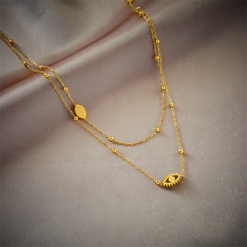 Minderheiten-Modedesign Doppellagige Mix-Kette Goldkugeln Titanstahl Tropföl Hohlblaue Augen Anhänger Halskette