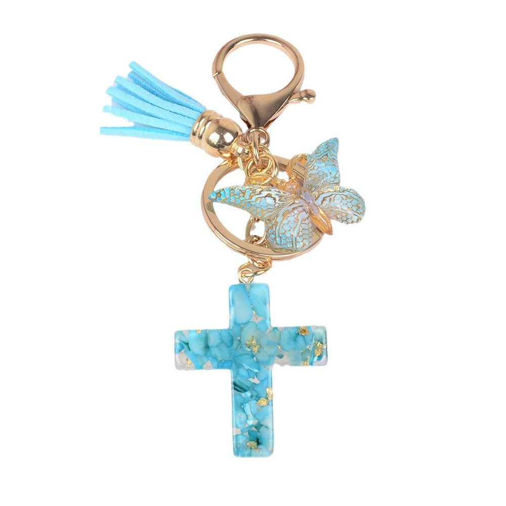 Llavero de cruz con borla y mariposa de piedra