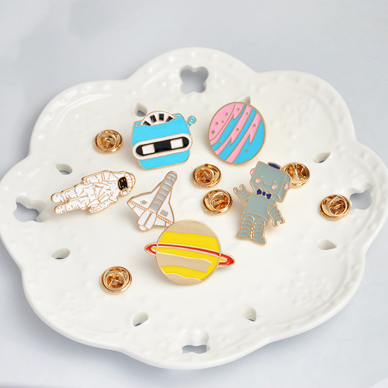 Broche de dibujos animados creativo de avión, astronauta, robot y planeta goteando