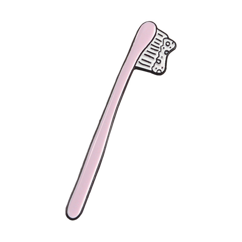 Lindo broche de pasta de dientes y cepillo de dientes de dibujos animados