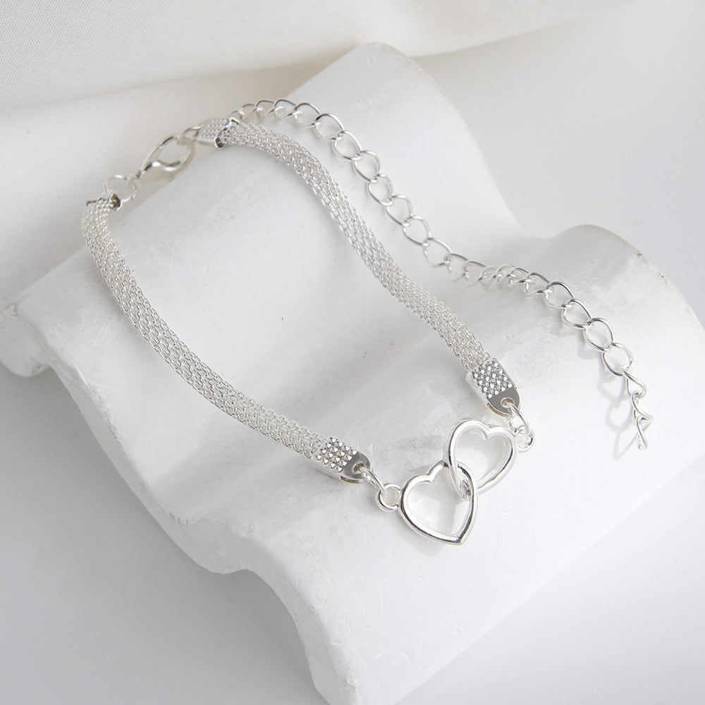 Tobillera de moda con cadena plana y dos corazones