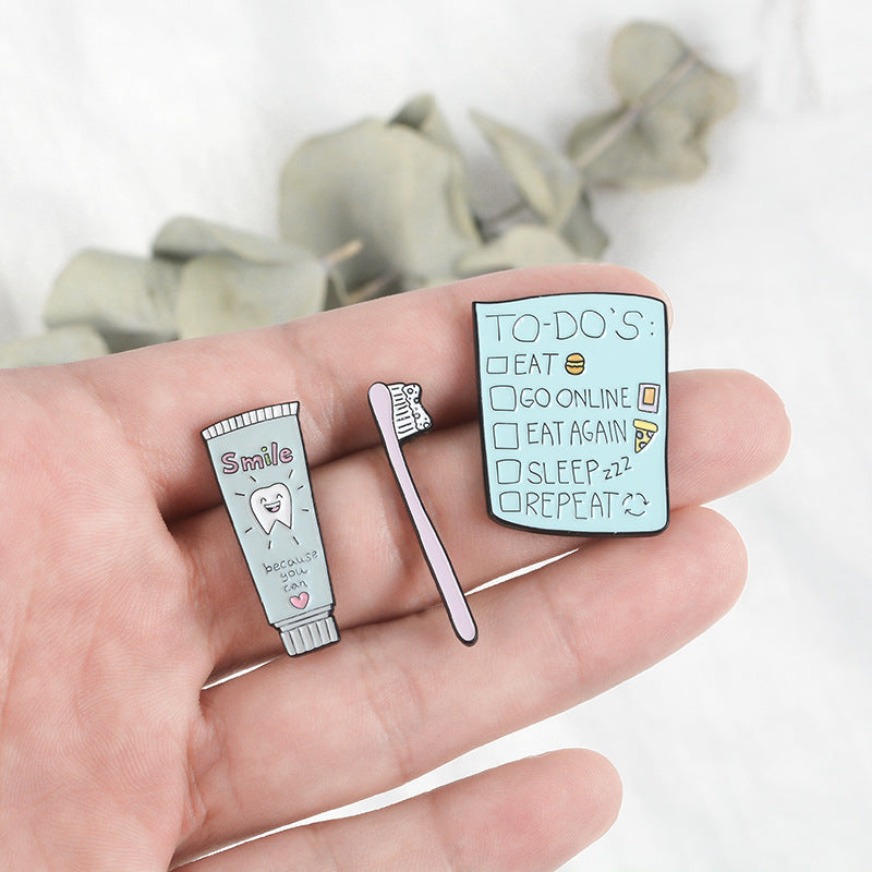 Lindo broche de pasta de dientes y cepillo de dientes de dibujos animados
