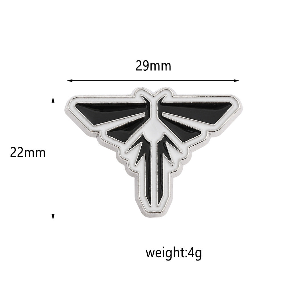 Broche de goteo de aceite con insignia M dorada