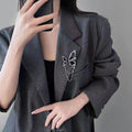 Broche con borlas de mariposa negro para mujer
