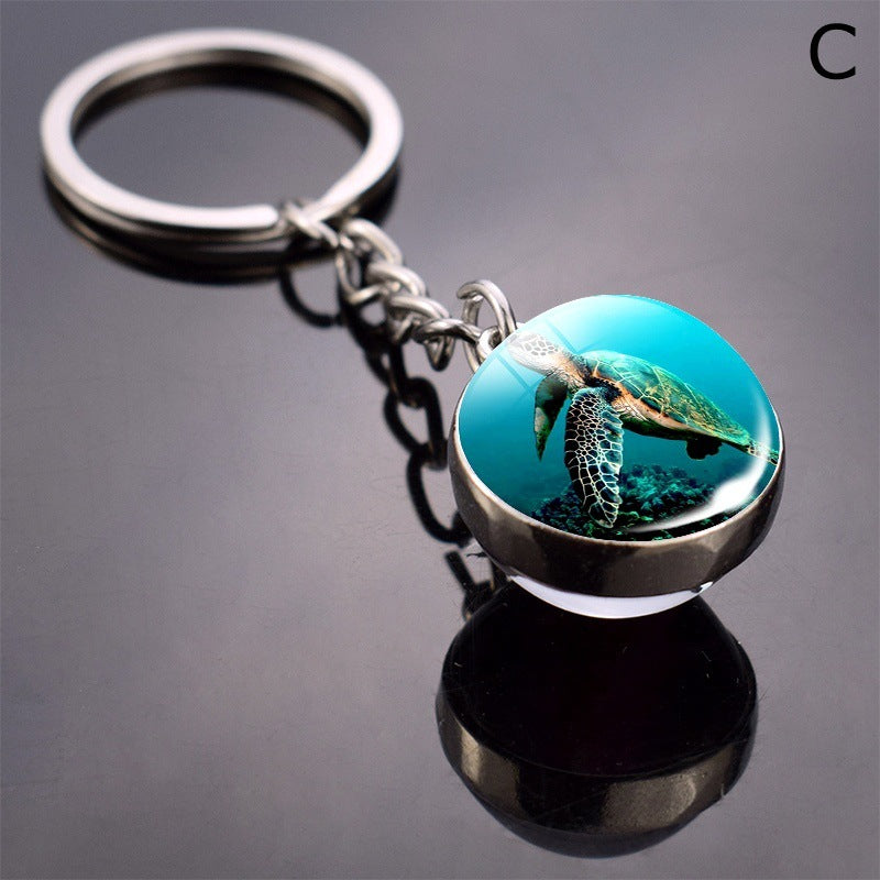 Llavero de bola de cristal con estrella de mar tortuga y animal divertido