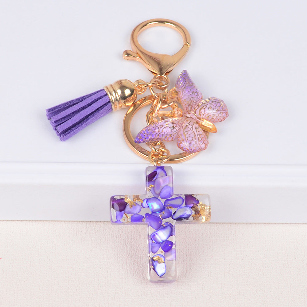Llavero de cruz con borla y mariposa de piedra