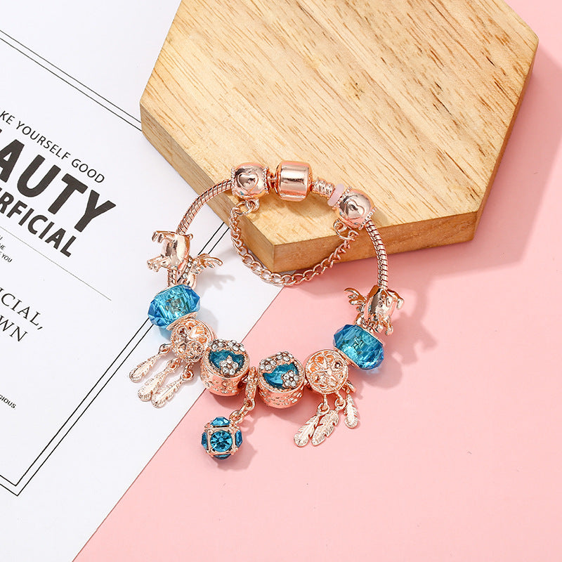 Pulsera de mujer con dije de borla magnética color oro rosado
